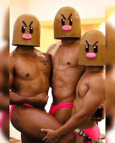 Three buff, muscled shirtless guys cosplaying as a slightly homoerotic Dugtrio, with dome-shaped Dugtrio masks over their heads.